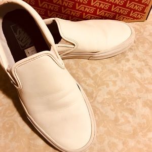 Vans, white leather slip-on sneakers.